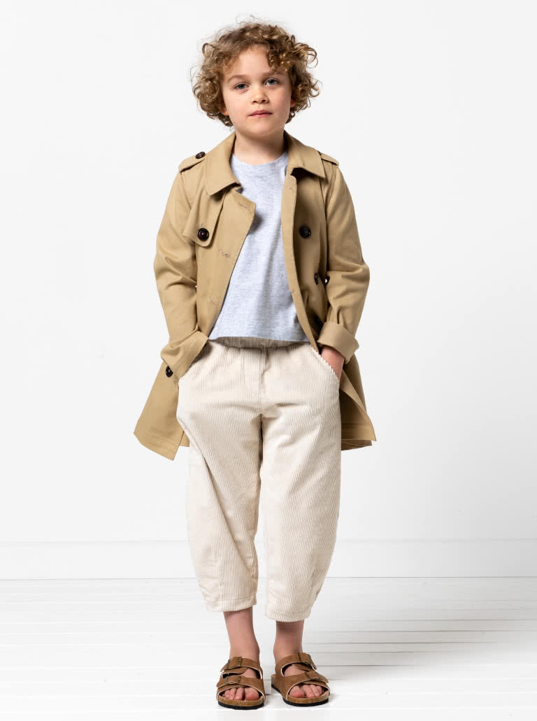 Camille Kids Trench By Style Arc - Option 1. Double breasted Trench coat with gathered skirt, belt and hood for kids 2-14. Option 2. Double breasted Trench coat straight through body, belt and hood for kids 2-14