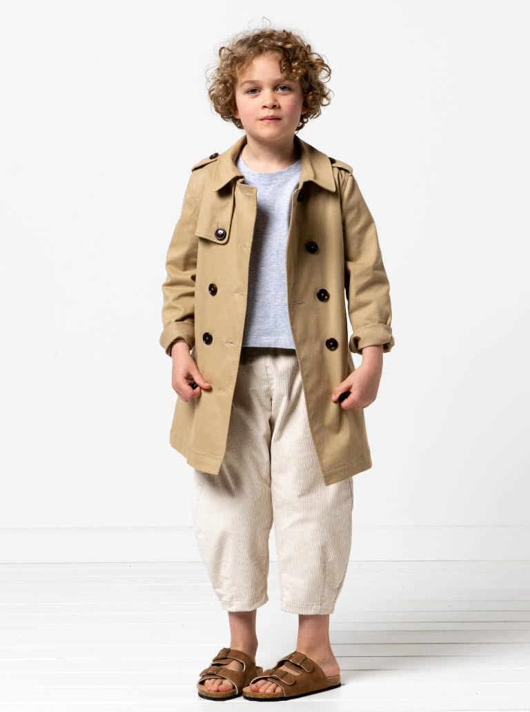 Camille Kids Trench By Style Arc - Option 1. Double breasted Trench coat with gathered skirt, belt and hood for kids 2-14. Option 2. Double breasted Trench coat straight through body, belt and hood for kids 2-14