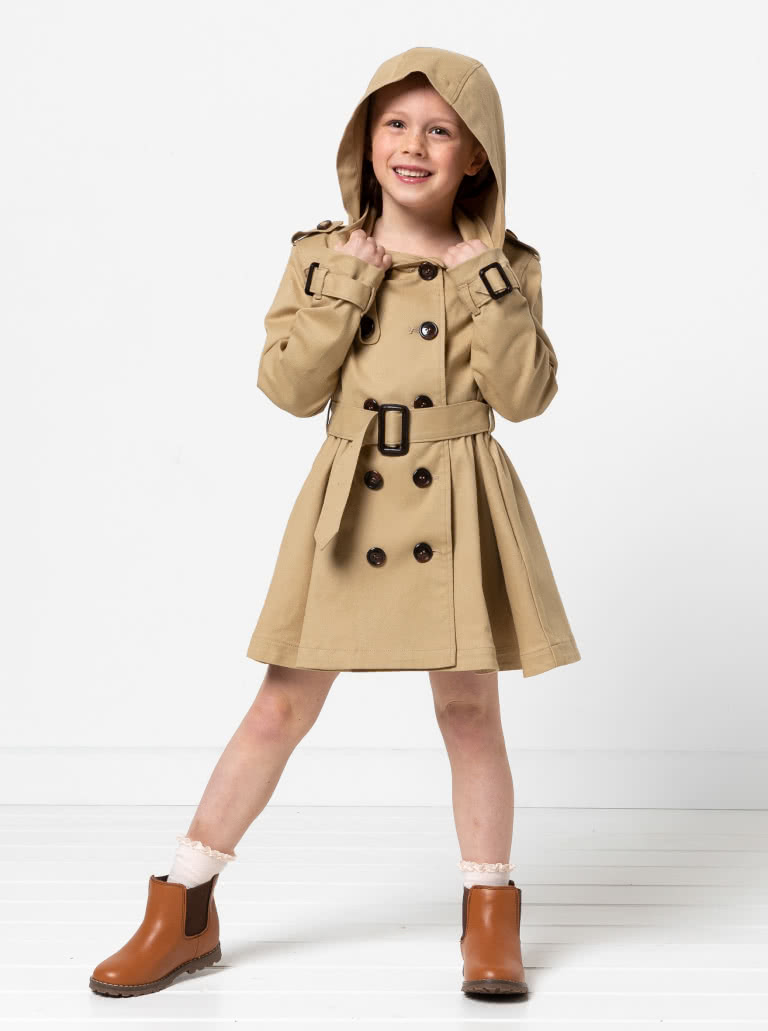 Camille Kids Trench By Style Arc - Option 1. Double breasted Trench coat with gathered skirt, belt and hood for kids 2-14. Option 2. Double breasted Trench coat straight through body, belt and hood for kids 2-14