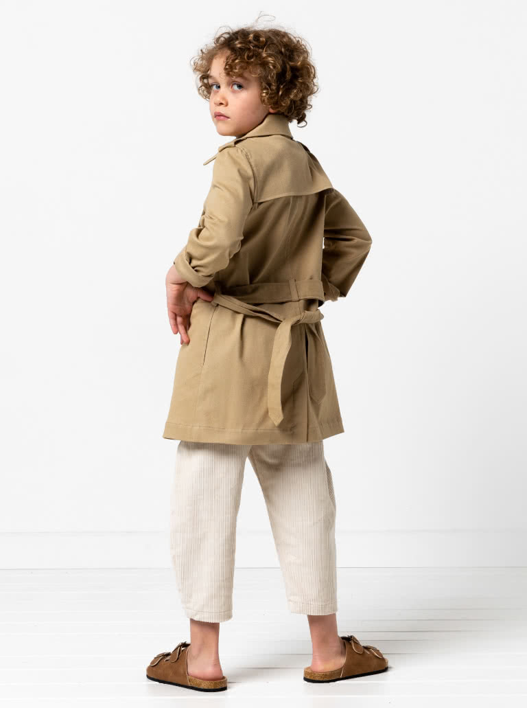 Camille Kids Trench By Style Arc - Option 1. Double breasted Trench coat with gathered skirt, belt and hood for kids 2-14. Option 2. Double breasted Trench coat straight through body, belt and hood for kids 2-14