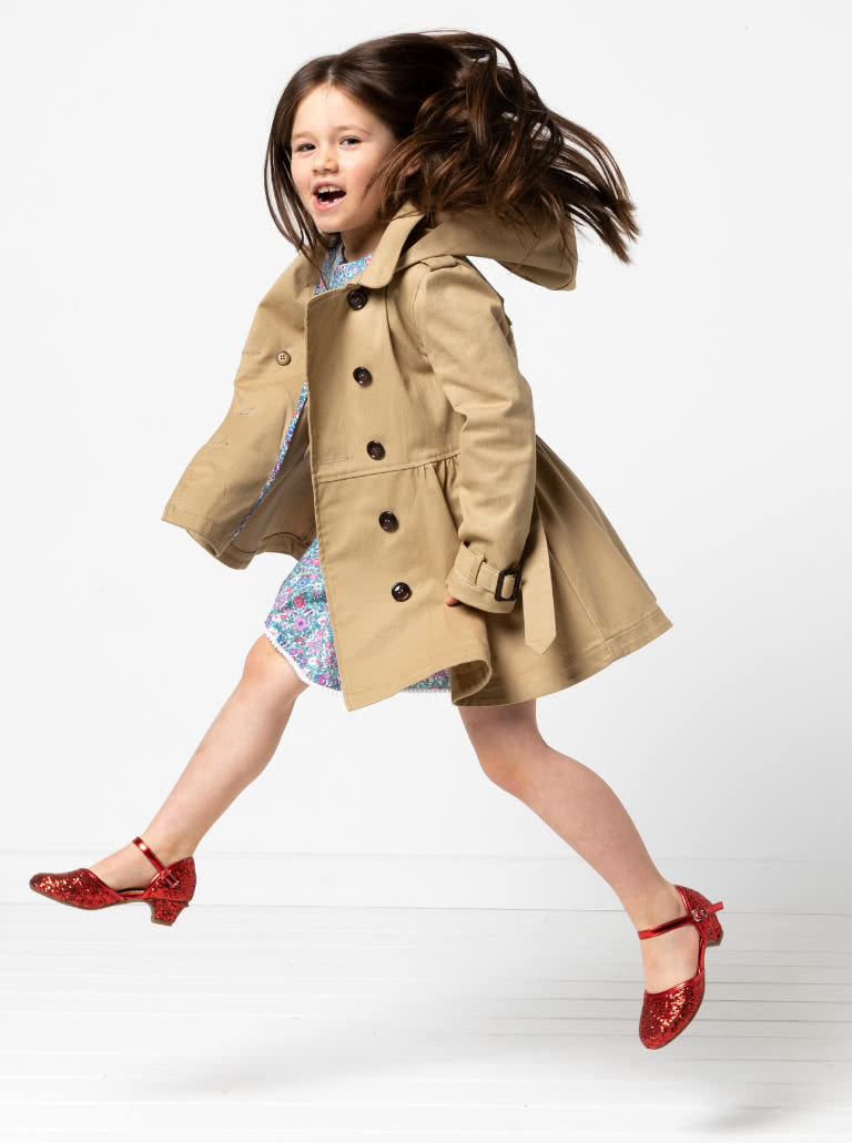 Camille Kids Trench By Style Arc - Option 1. Double breasted Trench coat with gathered skirt, belt and hood for kids 2-14. Option 2. Double breasted Trench coat straight through body, belt and hood for kids 2-14