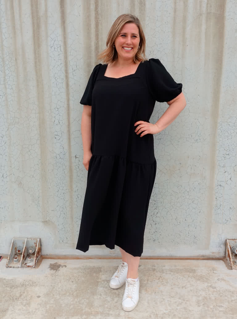Clementine Woven Top And Dress By Style Arc - Top: A-line top featuring a square neck and puffed elbow length sleeves. Dress: Calf length dress with one gathered lower tier.