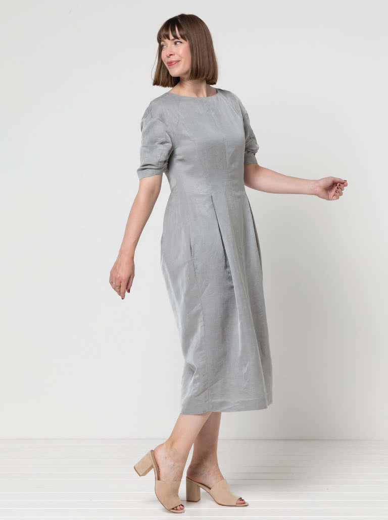 Gertrude Designer Dress By Style Arc - This is a designer dress featuring a fitted bodice, dropped shoulder line, tucked sleeves, inverted pleats and a back zip.